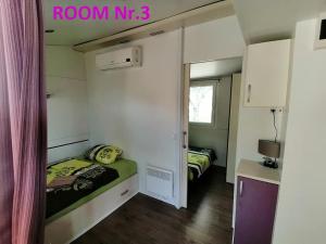 a small room with two beds in a room at MOBILE HOUSE KD in Tolmin