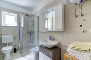 a bathroom with a sink toilet and a shower at Dora Apartment-Adults Only in Senj +123 photos