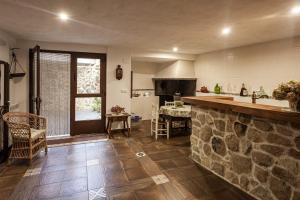a kitchen with a stone counter and a kitchen with a sink at Casa Rural La Fontanita in El Real de San Vicente