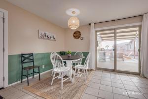 a dining room with a table and chairs at A WAVE FROM IT ALL - Pet & Family Friendly Home with Beautiful Views! in Lake Havasu City