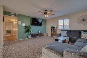 a living room with a couch and a ceiling fan at A WAVE FROM IT ALL - Pet & Family Friendly Home with Beautiful Views! in Lake Havasu City