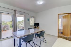 a dining room with a wooden table and chairs at Dora Apartment-Adults Only in Senj