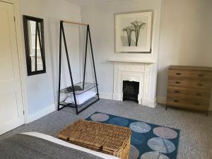 a living room with a swing and a fireplace at Invicta Apartment in Ashford