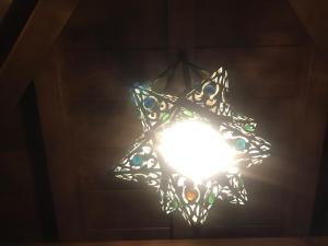 a light in a star shape hanging from a ceiling at La Casa del Castaño in Vegadeo +52 photos