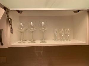 une rangée de verres à vin assis sur une étagère dans l'établissement New Sky Terrace, à Belgrade