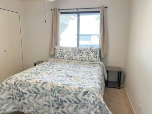 a bedroom with a bed with a large window at Cheerful Pool Home-Lowkey, 10min to Lake, Comfort in Lake Havasu City