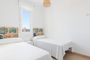 Posteľ alebo postele v izbe v ubytovaní Maravilloso adosado junto a la playa