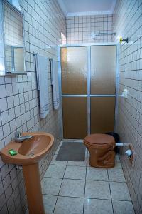 a bathroom with a shower and a toilet and a sink at RP HOTEL in Ribeirão Preto