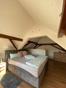 a bedroom with a bed in a attic at Ferienwohnung an der Unditz 3 in Neuried