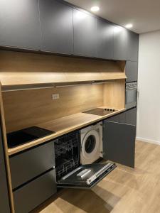 a kitchen with a washer and a microwave in it at Apartment Lana in Baška Voda