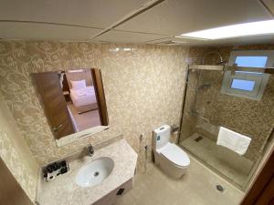 a bathroom with a sink and a toilet and a shower at Diamond Star Hotel فندق النجمة الماسية in Seeb