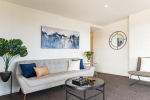 a living room with a couch and a table at Marina Cove Bay of Islands in Opua