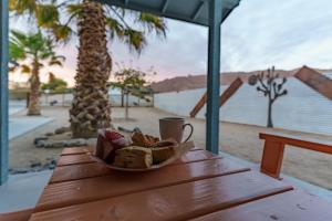 un tazón de pan y una taza de café sobre una mesa en Desert Twilight 29 - Hot Tub & EV Charger, en Twentynine Palms