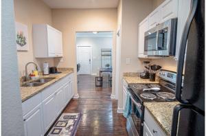 a kitchen with a sink and a stove top oven at Fabulous Newly Renovated 2Br1Ba Near Downtown in San Antonio
