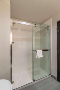 a shower with a glass door in a bathroom at Best Western Plus Tacoma Hotel in Tacoma