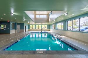 a swimming pool in a building with a large ceiling at Best Western Plus Tacoma Hotel in Tacoma