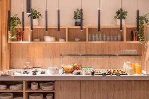 a kitchen with a buffet of food on a counter at Radisson Hotel Liege City Centre in Liège