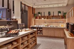 a kitchen with a counter with food on it at Radisson Hotel Liege City Centre in Liège