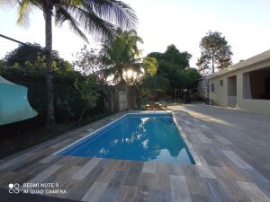 a swimming pool in the backyard of a house at Paraiso Hortensia Ecolodge in Santiago de los Caballeros