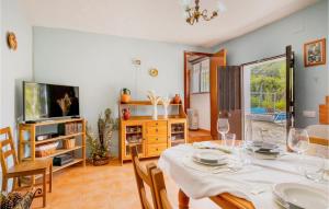 a dining room with a table and a tv at Awesome Home In Cortegana With Outdoor Swimming Pool in Cortegana