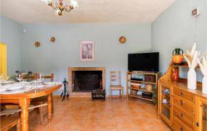 a living room with a table and a fireplace at Awesome Home In Cortegana With Wifi in Cortegana