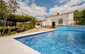 a swimming pool in front of a house at Awesome Home In Cortegana With Outdoor Swimming Pool in Cortegana