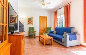 a living room with a blue couch and a tv at Cozy Apartment In Alcaucn With Wifi in Alcaucín