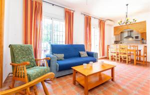 a living room with a blue couch and a table at Cozy Apartment In Alcaucn With Wifi in Alcaucín