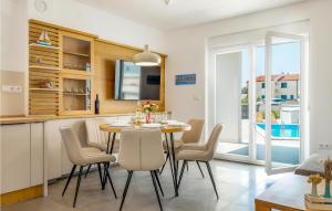 eine Küche und ein Esszimmer mit einem Tisch und Stühlen in der Unterkunft Nice Home In Sibenik With Kitchen in Šibenik