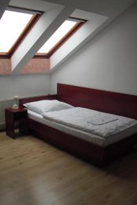un letto in una camera con lucernari di Restaurant Švejk a Pension Brno a Brno