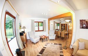 a living room with white chairs and a dining room at Ferienhaus 11 In Kirchheim in Kirchheim