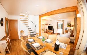 a dining room with a table and a spiral staircase at Ferienhaus 11 In Kirchheim in Kirchheim
