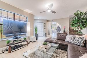 a living room with a couch and a large screen tv at Luxury Holistic Oasis by Bayshore/Hyde Park/SoHo in Tampa