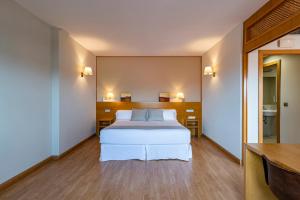 Hotel Viadero tesisinde bir odada yatak veya yataklar