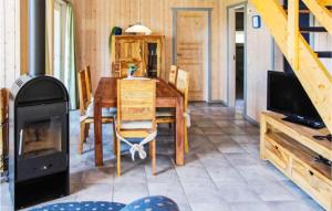 een eetkamer met een tafel en een houtkachel bij 2 Bedroom Gorgeous Home In Rechlin in Rechlin