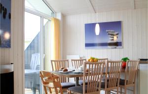 a dining room with a table and chairs at Friedrichskoog-Deichblick 5 in Friedrichskoog +7 photos