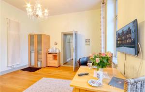 a living room with a table with flowers on it at Cozy Apartment In Krakow Am See With Kitchenette in Krakow am See