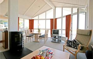 a living room with a table and chairs and a living room at Friedrichskoog-strandpark 14 in Friedrichskoog