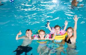 a group of children swimming in a swimming pool at Dream place “Noah’sHope” in Leysdown-on-Sea