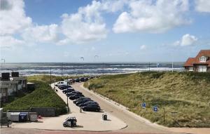a row of cars parked on a road next to the beach at De Tuimelaar in Bergen aan Zee +13 photos