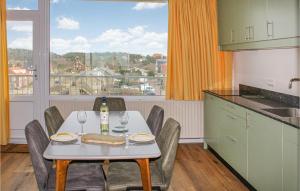 a kitchen with a table with a bottle of wine at De Tuimelaar in Bergen aan Zee