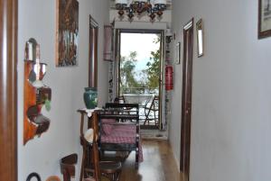 a hallway with a table and chairs in a room at Paris & Eleni in Afissos