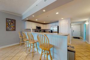 a kitchen with a bar with stools at Bahia Vista II 305 in Ocean City
