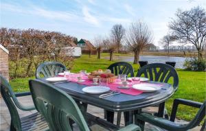 a blue table with chairs and a table with food on it at Lovely Home In Vlagtwedde With Sauna in Vlagtwedde +20 photos