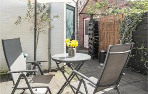 a table and chairs on a patio with yellow flowers at Lindegracht in Alkmaar