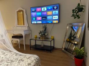 A television and/or entertainment center at Chambre d'hôte close to the Airport MED 5 & market