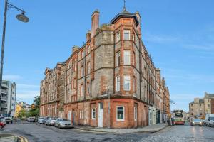 an old brick building on the corner of a street at Private Ground Floor Main Door Entrance - Spacious 2 Bedroom Property - The Shore, Leith in Edinburgh