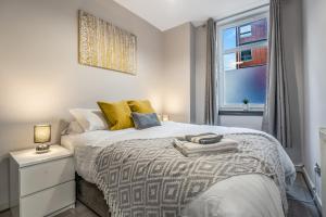 a bedroom with a large bed with a window at Private Ground Floor Main Door Entrance - Spacious 2 Bedroom Property - The Shore, Leith in Edinburgh