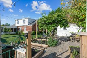 a backyard with a garden and a house at "Sweet Serenity" Stay 10 Minutes from Hershey home in Palmyra