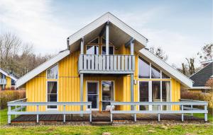 a yellow house with a large front porch at Nice Home In Rechlin With Sauna in Rechlin